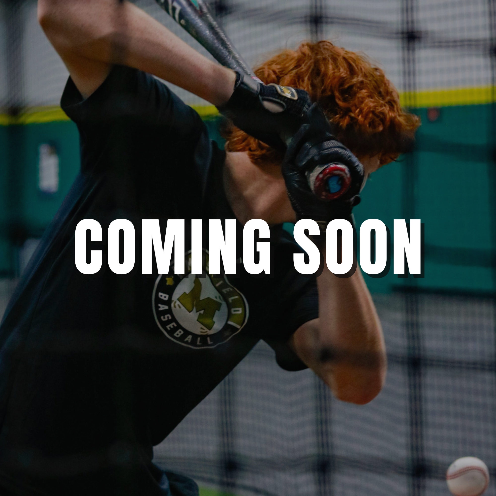 A baseball hitter follows through on a powerful swing at home plate.